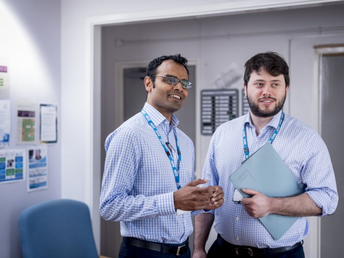 Men standing, looking off camera, primary care, ward