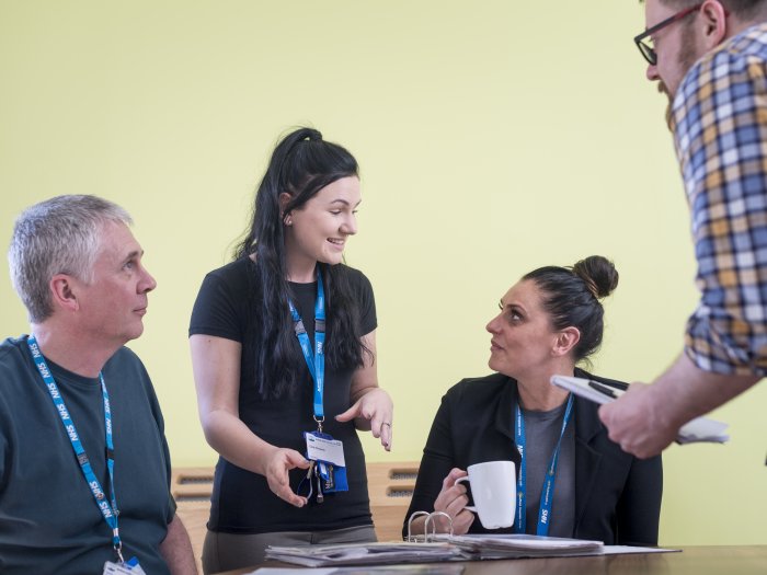 two men and two women in a meeting