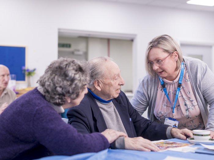 Woman clinician medic talking to an elderly man and woman (2)