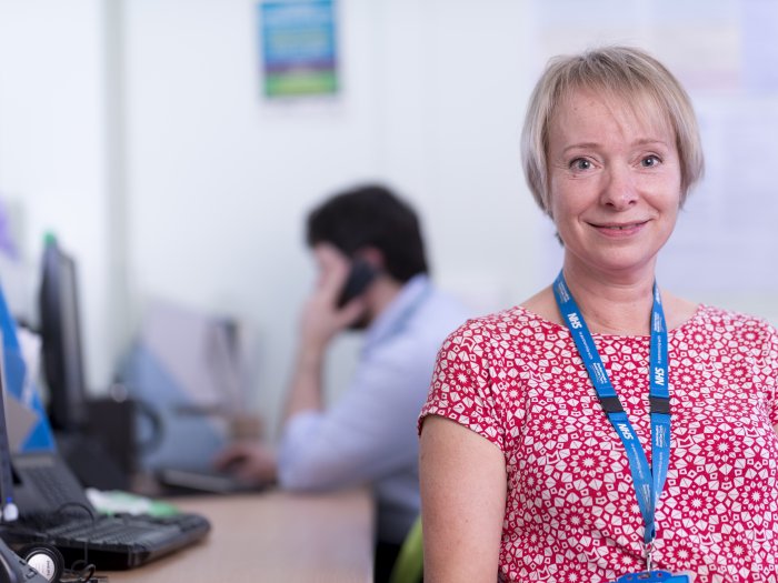 woman in office looking at camera