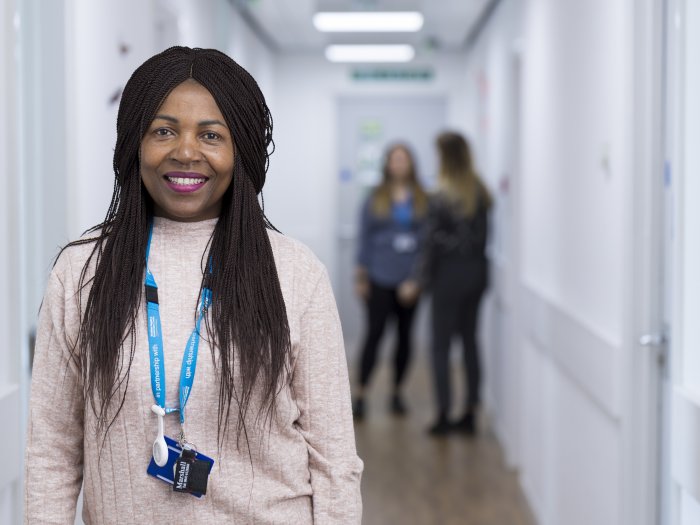 woman medic, clinician, looking at camera, smiling broadly