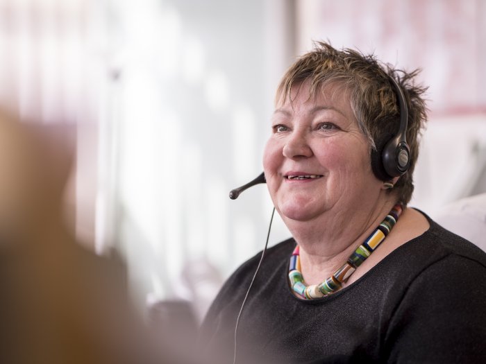 Woman talking on headset, smiling