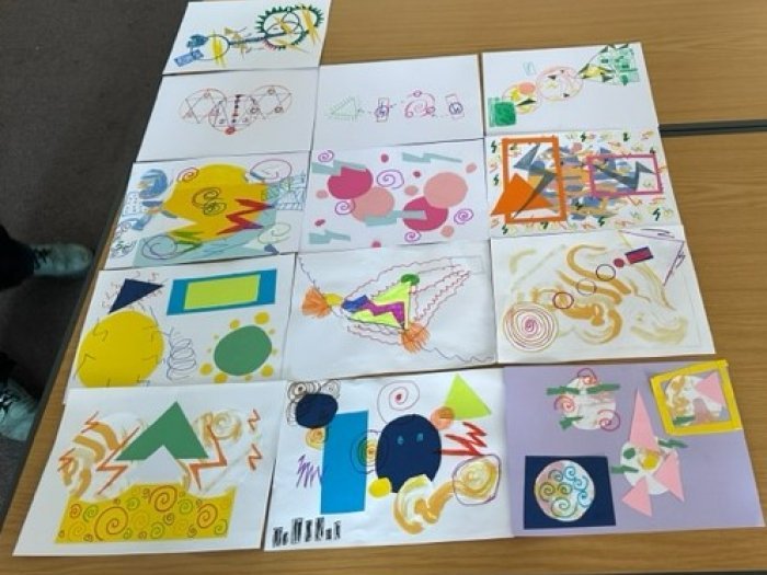 Artwork laid out on a table depicting experiences of cancer screening