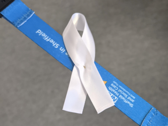 White ribbon on NHS lanyard