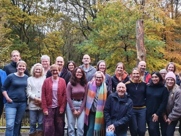 Specialist psychotherapy service team stood together in a wooded area