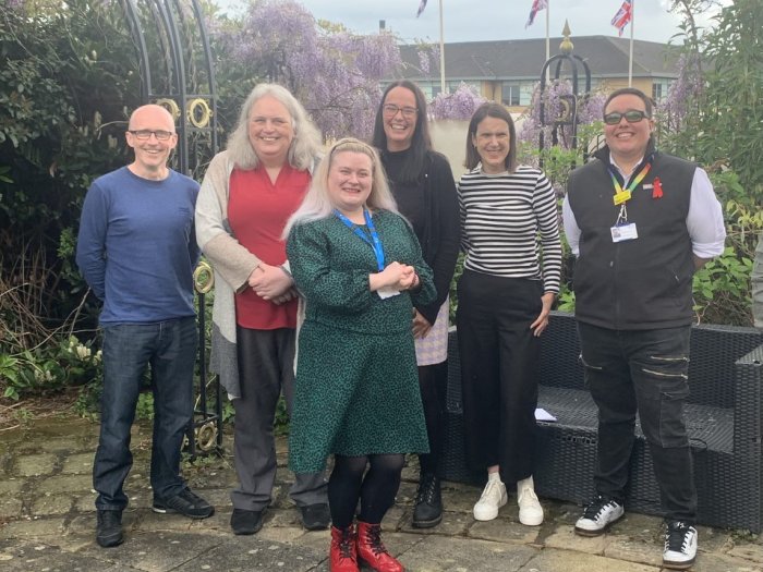 Peer support workers stood in a group smiling