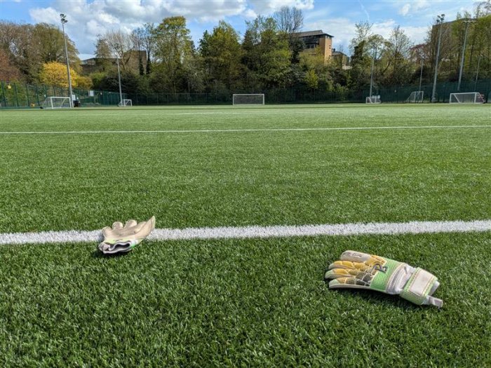 Goalkeeper gloves on a football pitch