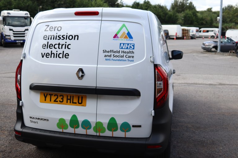 white van with livery showing it is an electric vehicle