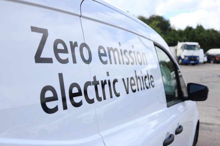white van with livery showing it is an electric vehicle