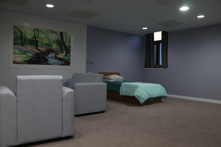Large bedroom in low green light