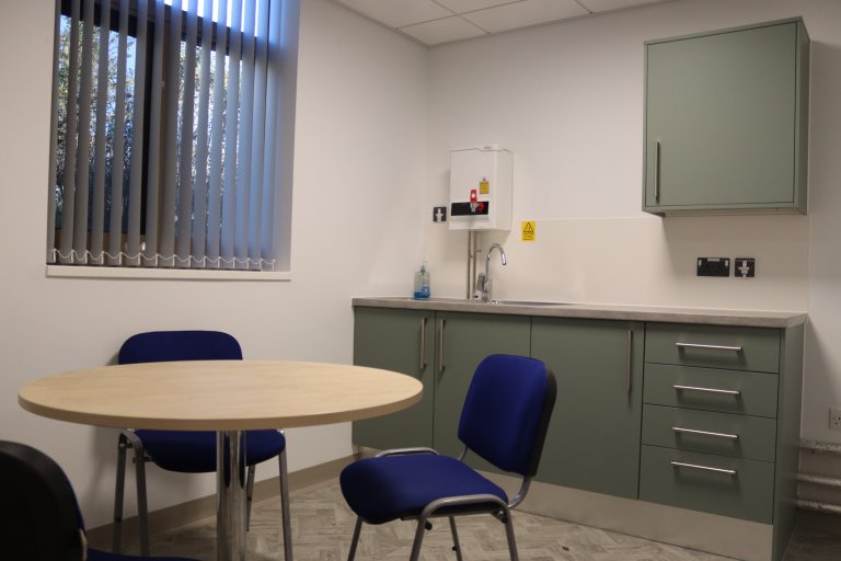 Staff kitchen with worktop and round table with chairs