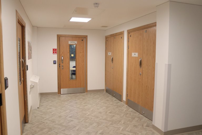 Corridor with staff kitchen at end